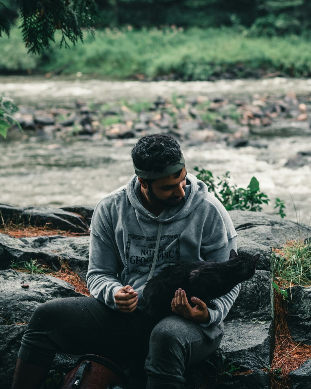 Portrait of an Indigenous Canadian man holding a notebook on a city street