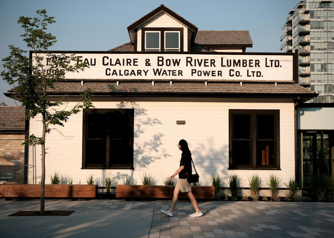 Commuters walking through downtown Calgary with the Bow skyscraper in the background